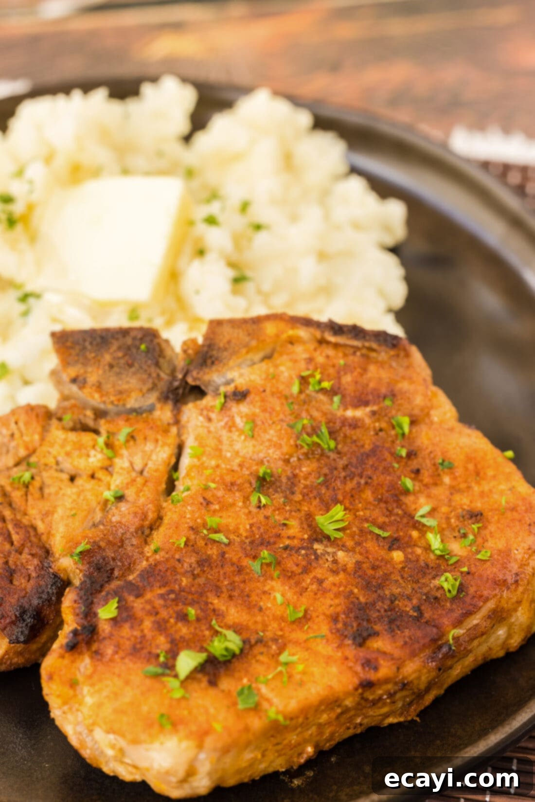Tender Instant Pot Pork Chops 9 Close up of a Instant Pot Pork Chop on a plate