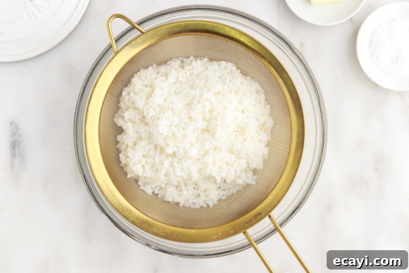 Perfect Fluffy Rice Every Time 12 draining cooked rice in a bowl after boiling