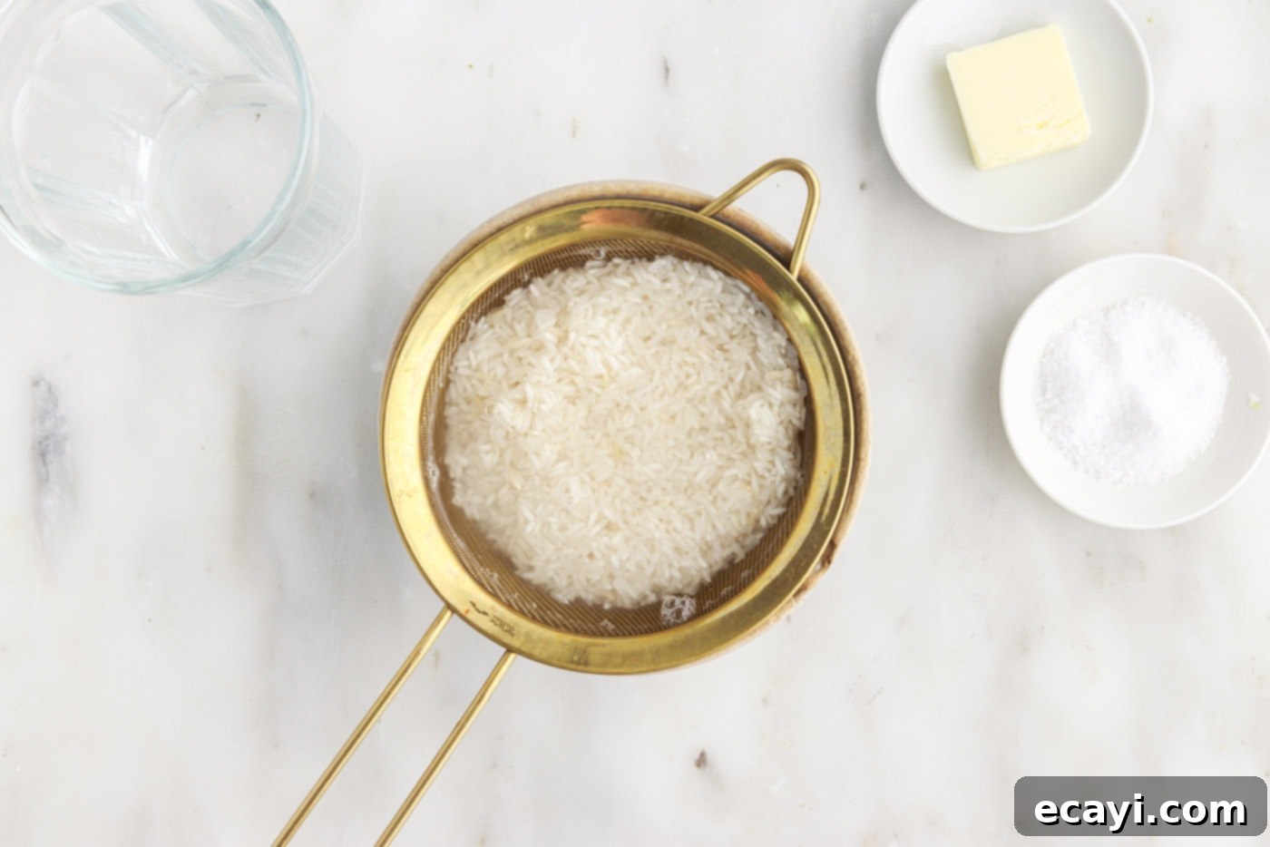 Perfect Fluffy Rice Every Time 6 rinsing rice with water in a sieve, showing clear water
