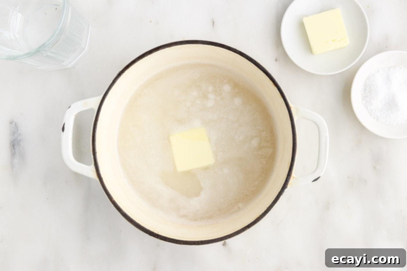 Perfect Fluffy Rice Every Time 8 butter added to rice and water in a saucepan