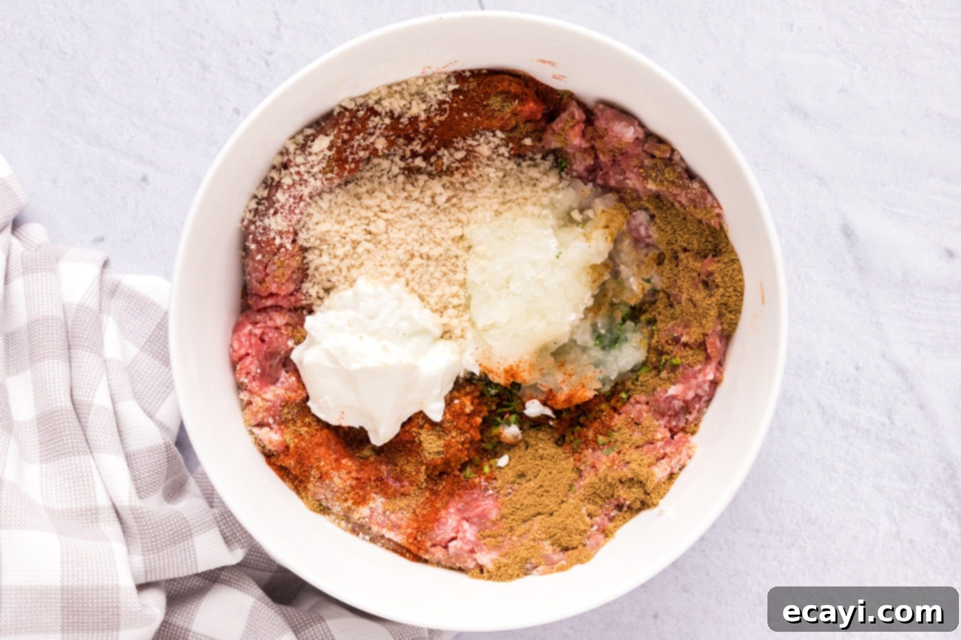 Aromatic Lamb Kofta 5 ground lamb with breadcrumbs, seasonings, onion, and greek yogurt in a bowl