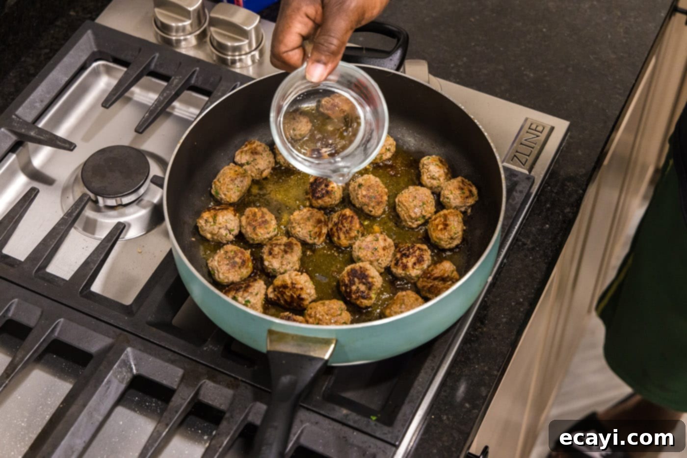 Aromatic Lamb Kofta 8 adding water to meatballs in a skillet