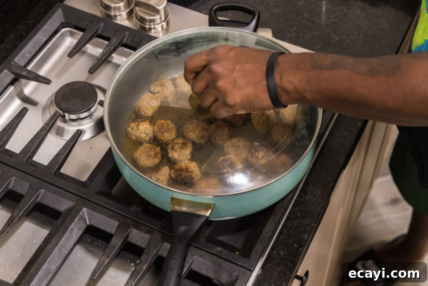 Aromatic Lamb Kofta 9 adding a lid to skillet with meatballs