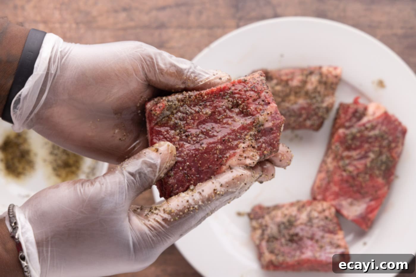 Slow-Cooked Beef Short Ribs 6 Rubbing pepper and garlic salt on beef short ribs