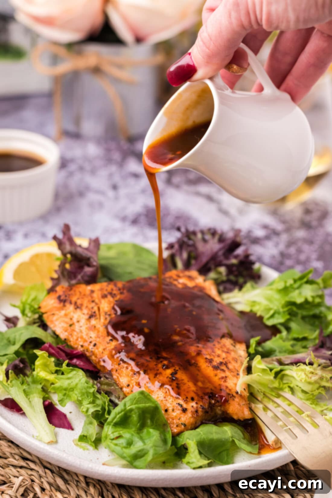 Velvet Salmon Glaze 2 Salmon Sauce being drizzled on a piece of salmon
