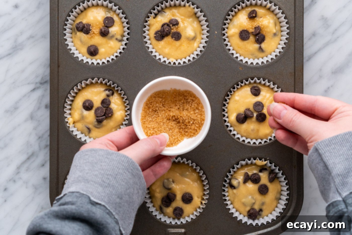 Heavenly Chocolate Chip Bites 15 sprinkling sugar in the raw on top of muffin batter
