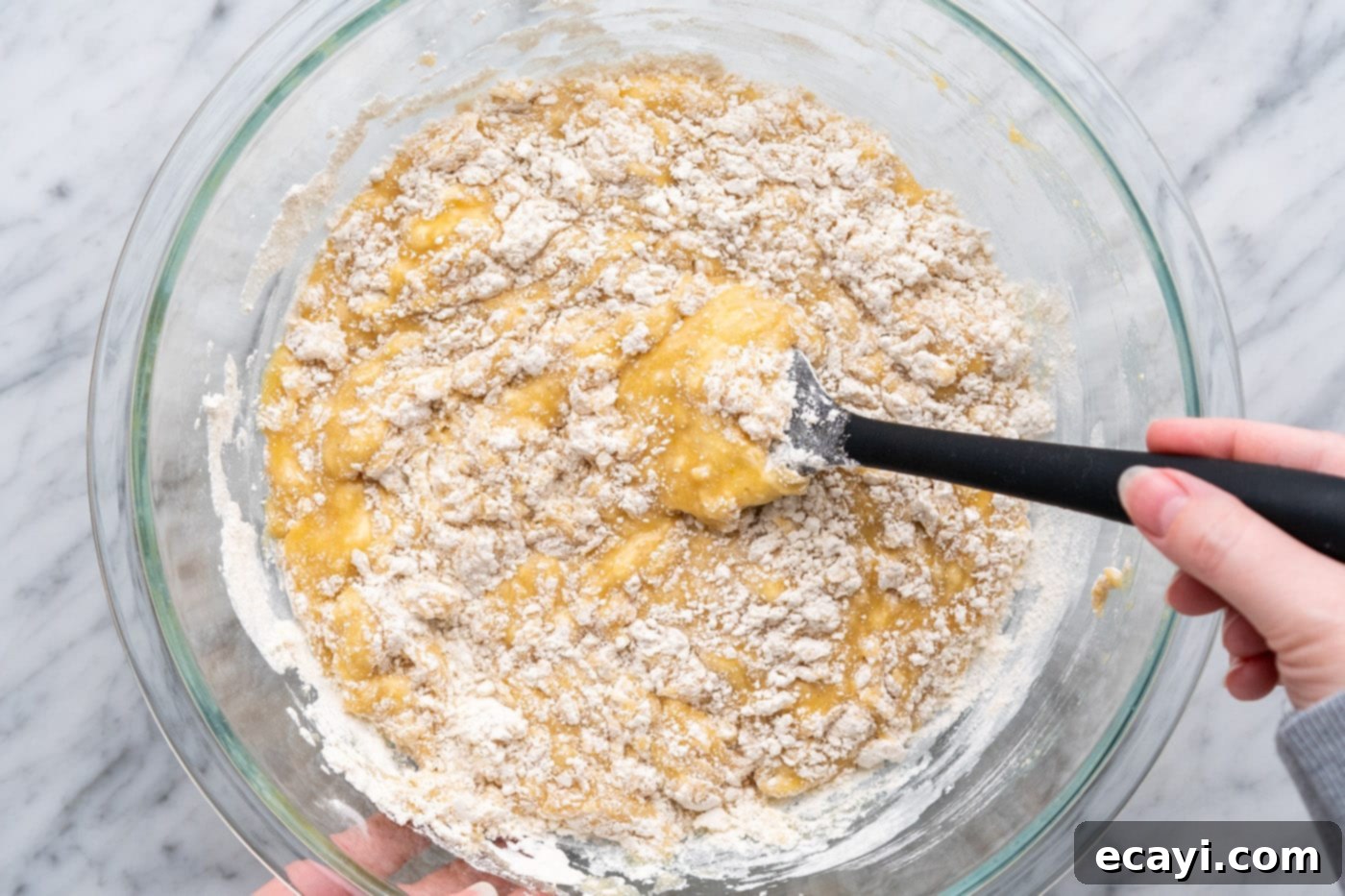 Heavenly Chocolate Chip Bites 10 folding and incorporating muffin batter together in a bowl