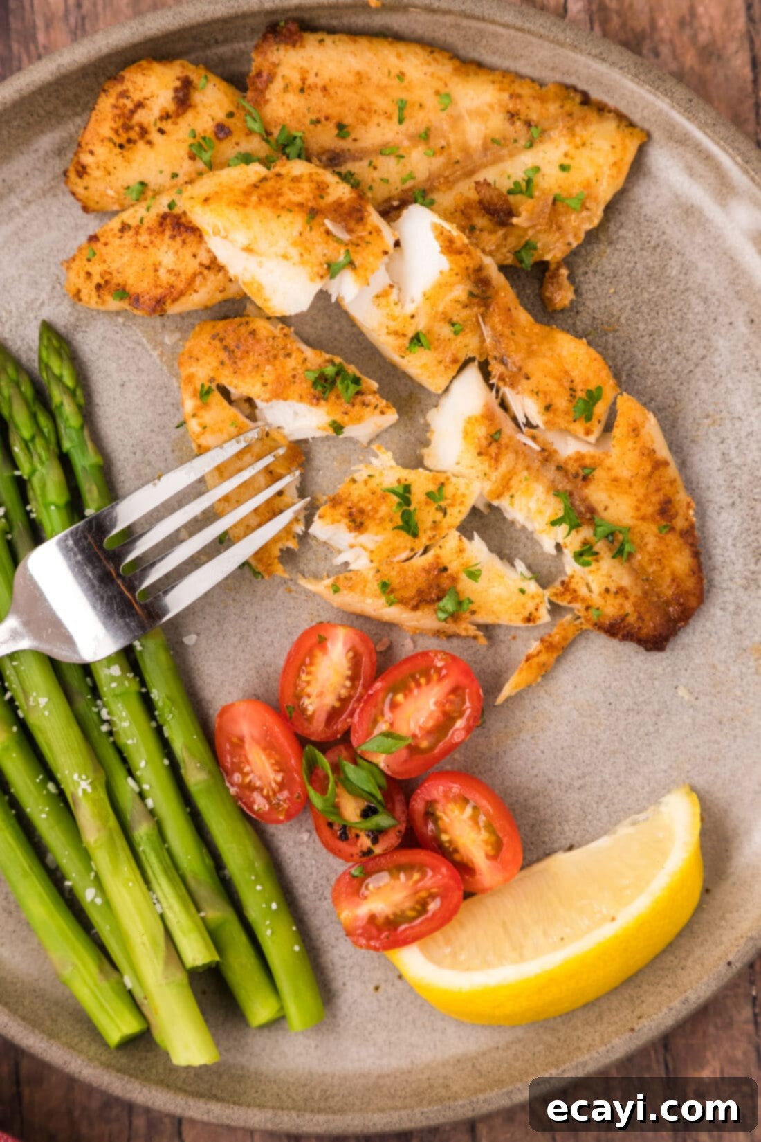 The Ageless Orange of the Depths 2 Tender, flakey Pan-Seared Orange Roughy broken apart on a plate with a fork, ready to eat