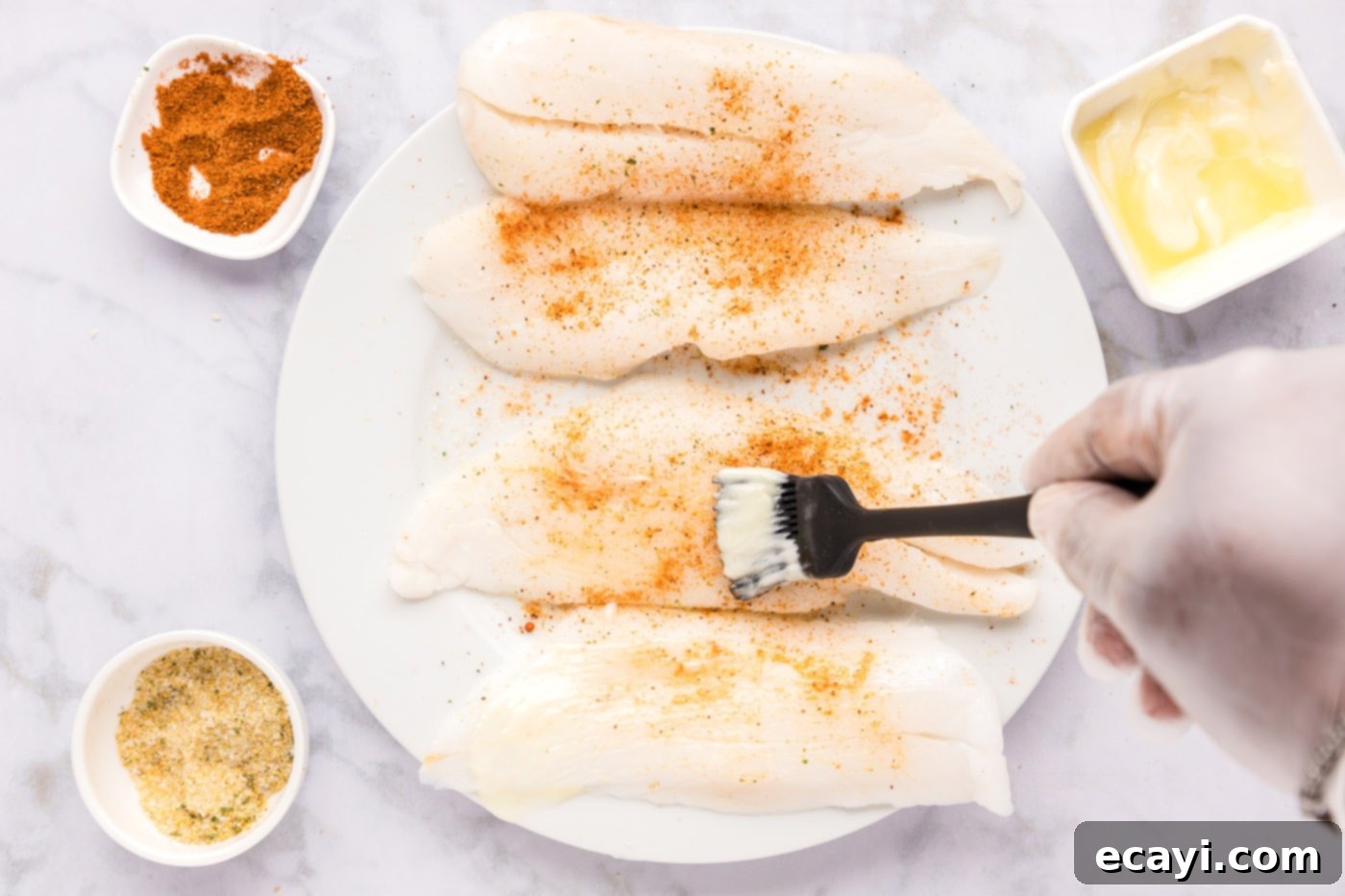 The Ageless Orange of the Depths 7 Brushing softened butter onto seasoned orange roughy filets before searing