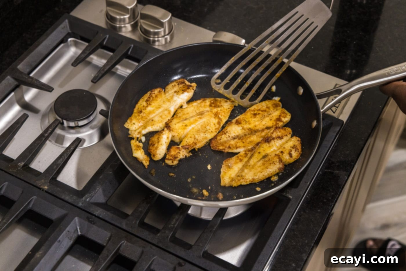 The Ageless Orange of the Depths 9 Fish turner spatula flipping orange roughy filets in a skillet during searing