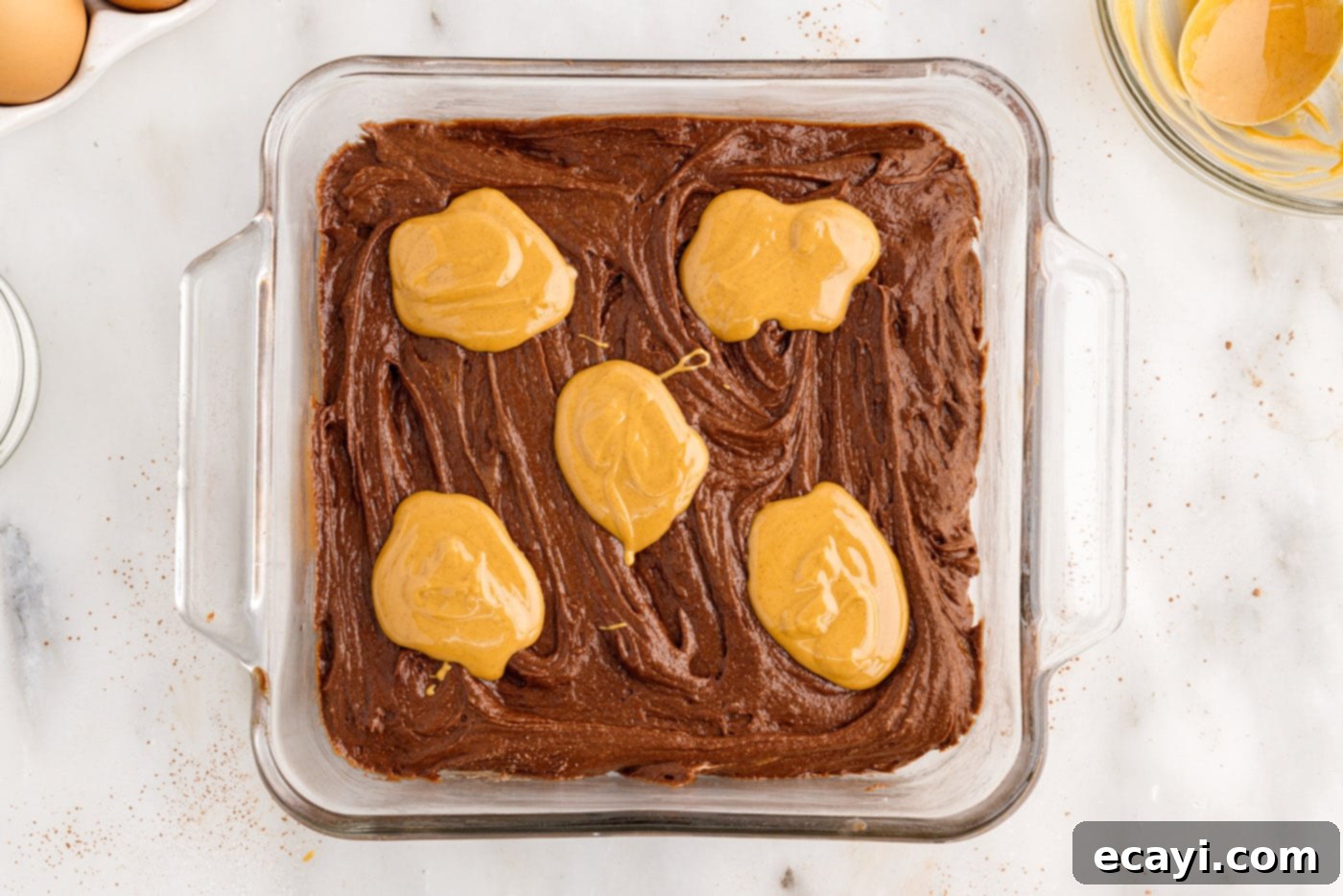 Peanut Butter Brownie Bliss 12 dollops of melted peanut butter on top of brownie batter