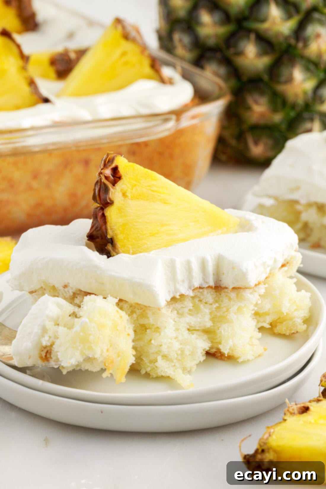Tropical Pineapple Angel Delight 3 Square of Pineapple Angel Food Cake with a fork on the side, showing its light texture