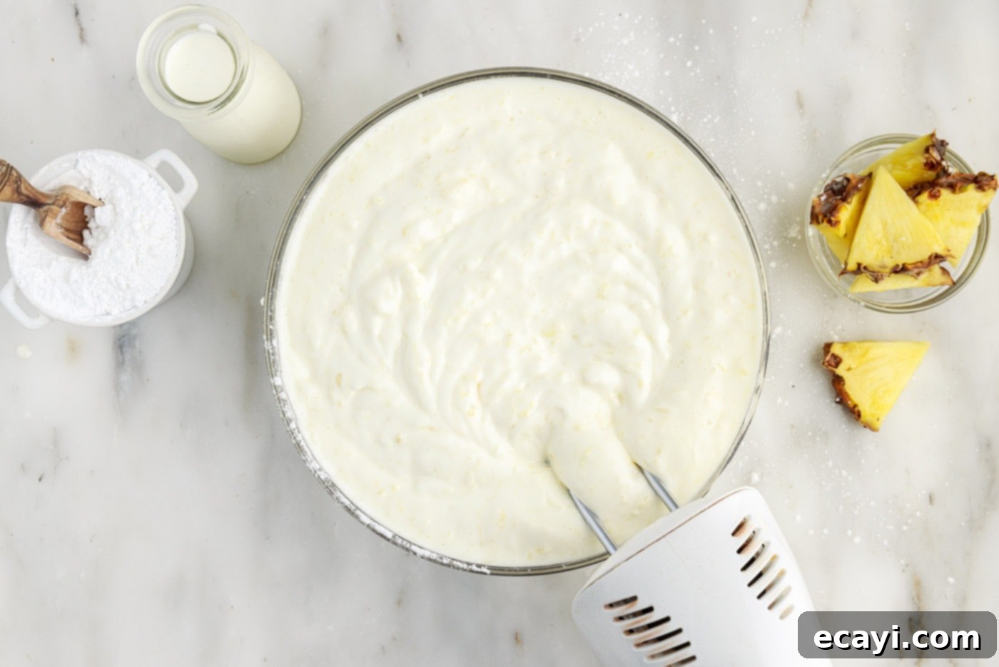Tropical Pineapple Angel Delight 6 hand mixer combining crushed pineapple and angel food cake mix in a bowl