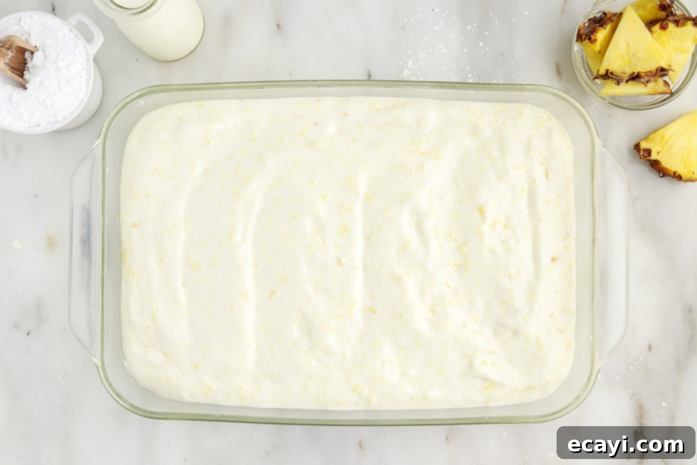 Tropical Pineapple Angel Delight 7 pineapple angel food cake batter evenly spread in a 9x13 baking dish
