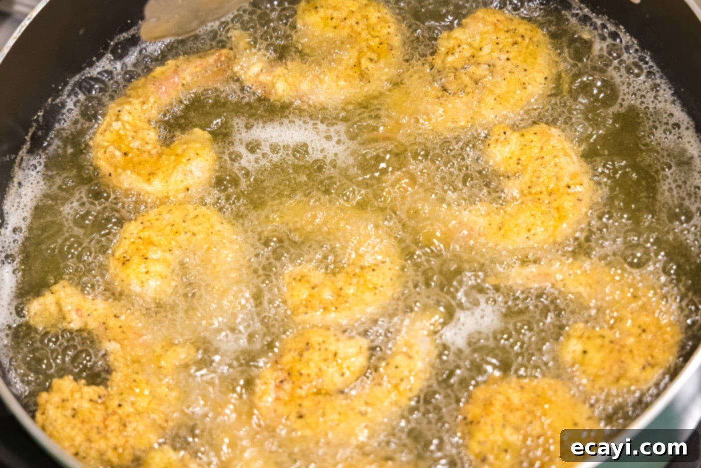 Golden Crispy Shrimp 13 fried shrimp cooked in oil on the stovetop