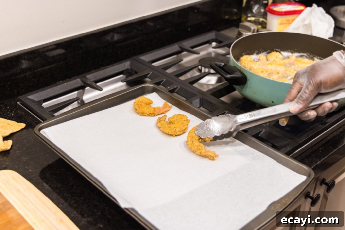 Golden Crispy Shrimp 14 removing fried shrimp from oil and placing on paper towels