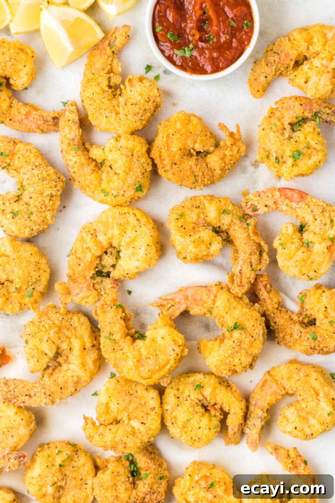 Golden Crispy Shrimp 3 Close up of a pan of Fried Shrimp with a bowl of cocktail sauce
