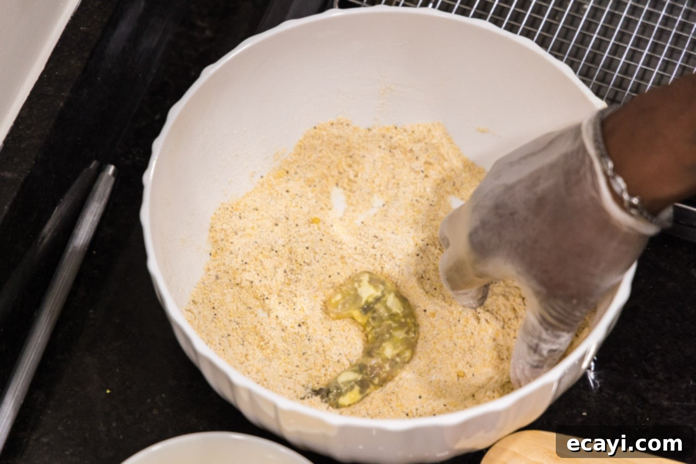 Golden Crispy Shrimp 10 dredged shrimp in a bowl with cornmeal mixture