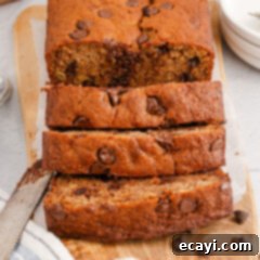 Banana Chip Indulgence 17 Close up of a loaf of Chocolate Chip Banana Bread cut in slices, showing the moist interior and melted chocolate.