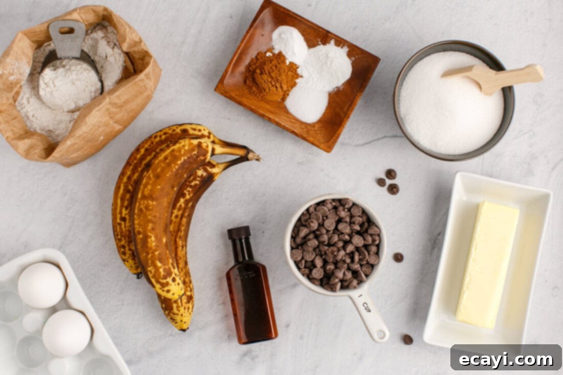 Banana Chip Indulgence 4 All the necessary ingredients laid out for making chocolate chip banana bread, including ripe bananas, flour, sugar, butter, eggs, and chocolate chips.
