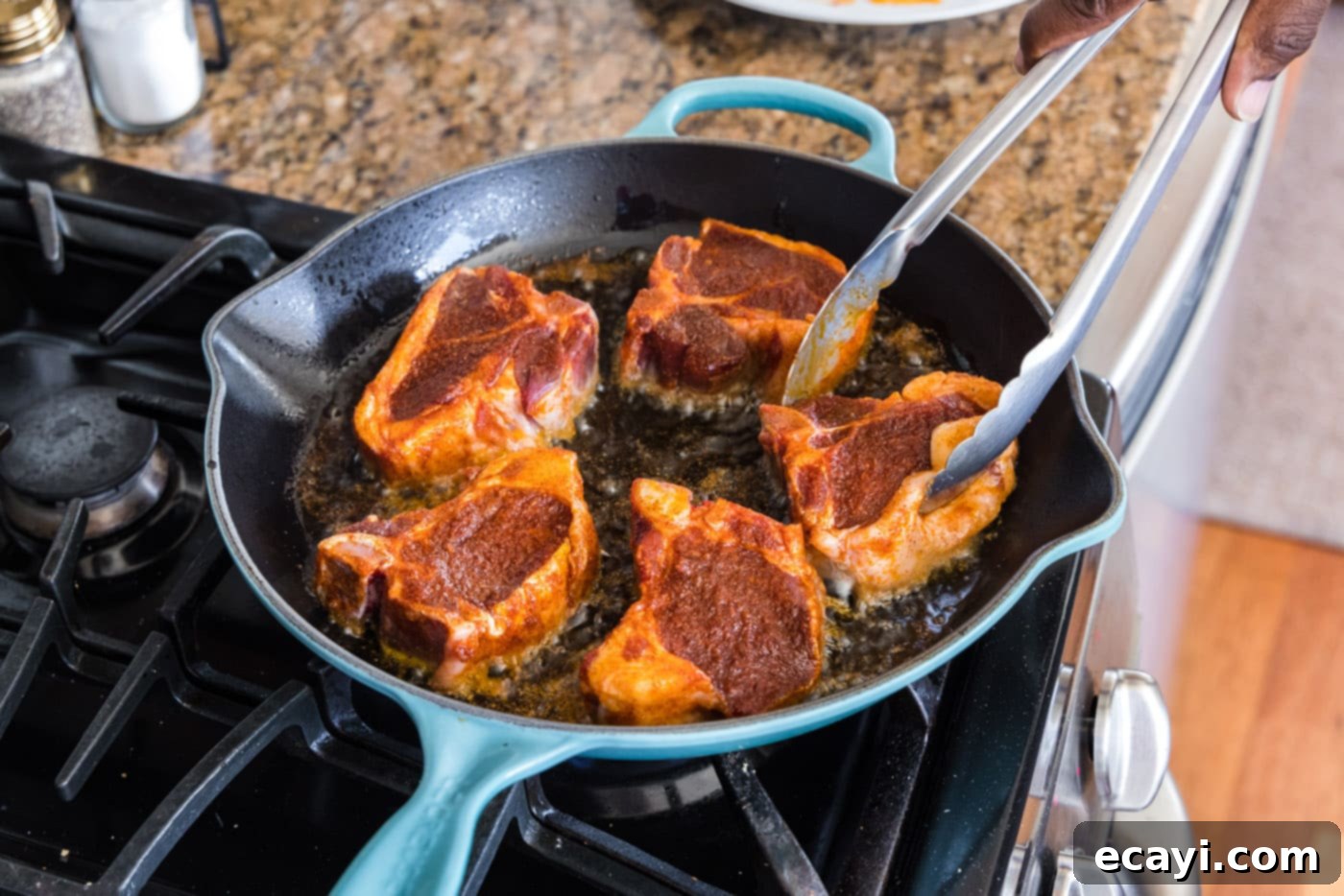 Seared Lamb Loin Chops 8 turning lamb loin chops over in a skillet with tongs