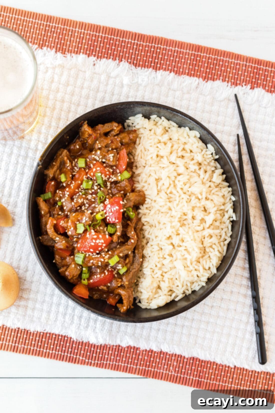 Crispy Beijing Beef 12 An inviting overhead shot of Beijing Beef with rice in a white bowl, ready to be enjoyed.