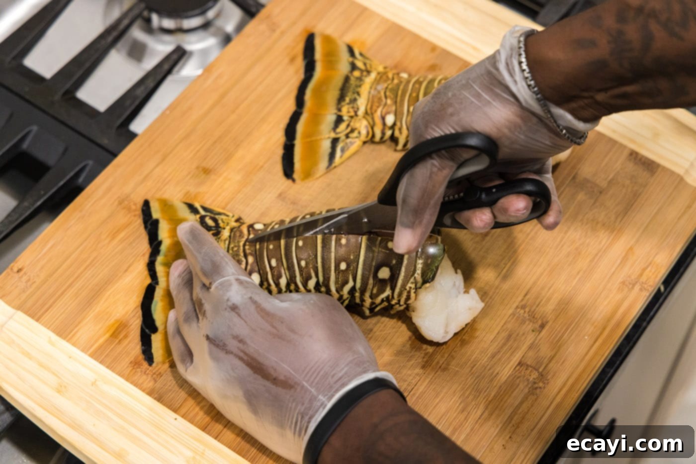 Succulent Grilled Lobster Tail 5 using kitchen shears to cut down the center of lobster tails