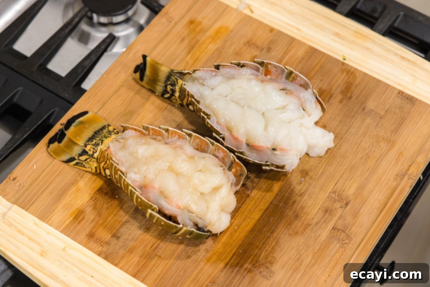 Succulent Grilled Lobster Tail 8 butterflied lobster tail on a cutting board