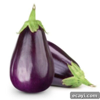 Düşük Karbonhidratlı Sebzeler: Ne Yenmeli, Nelerden Kaçınmalı 12 A dark purple eggplant isolated on a white background, showcasing its sleek form.