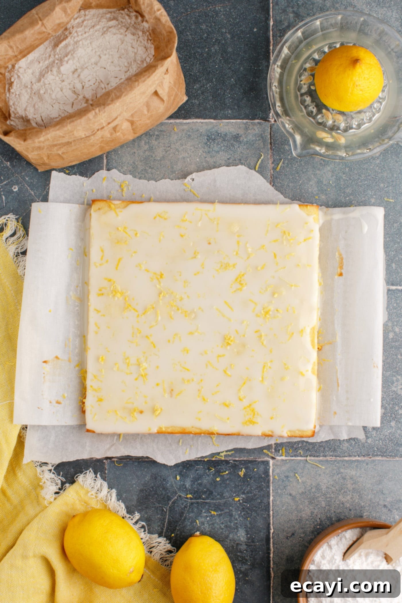 Sunshine Lemon Brownies 11 overhead shot of lemon glazed brownies with lemon zest sprinkled on top, ready to be cut