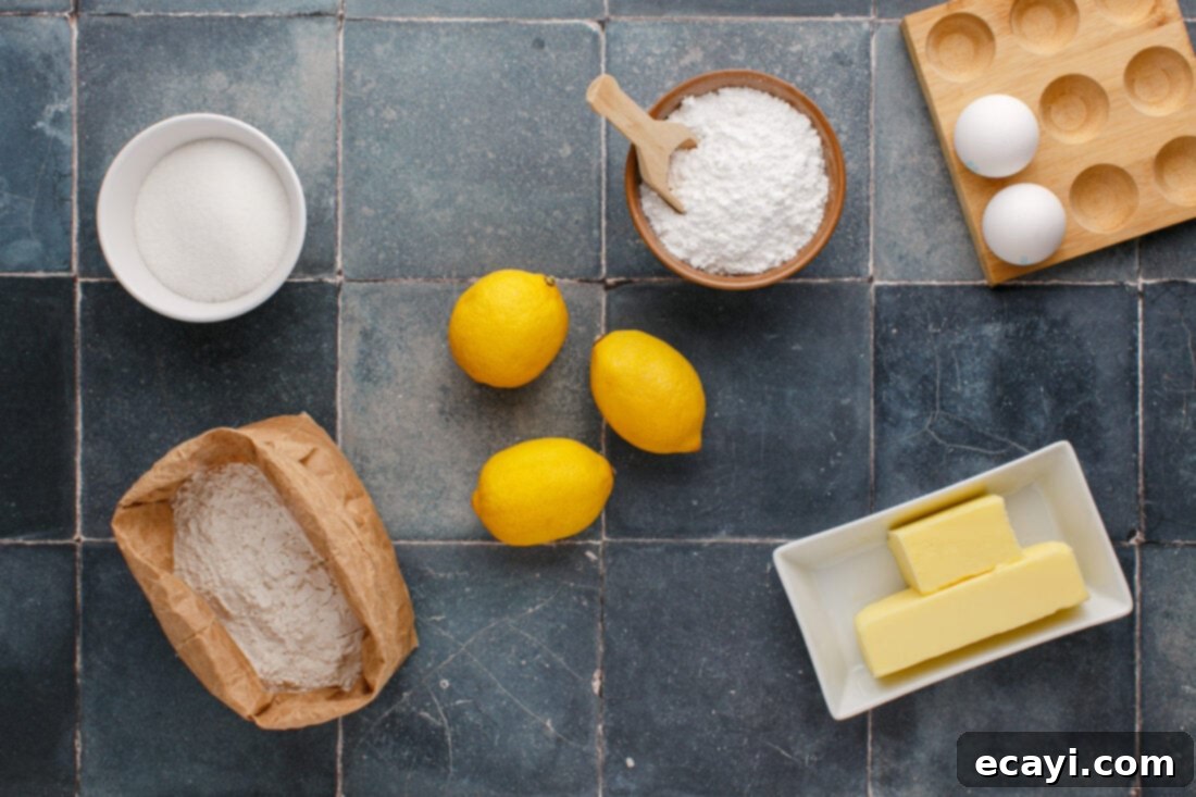 Sunshine Lemon Brownies 4 Various ingredients for lemon brownies laid out on a surface, including lemons, butter, sugar, eggs, and flour