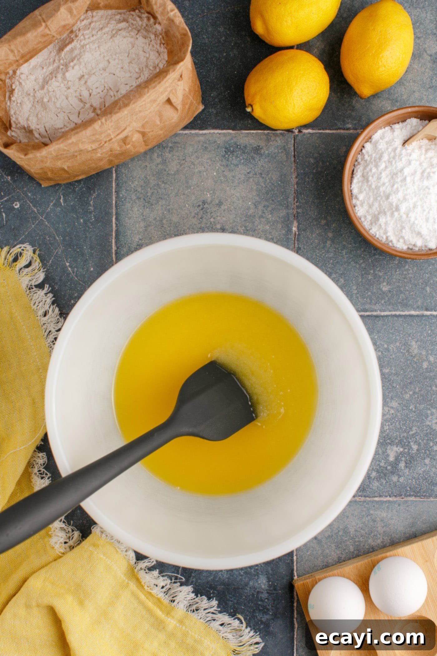 Sunshine Lemon Brownies 5 melted butter and sugar mixed in a bowl with a spatula