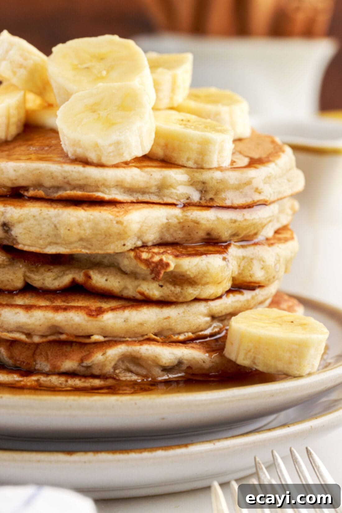 Fluffy Banana Bliss 13 Close up view of a stack of fluffy banana pancakes, showing their golden-brown exterior and soft texture