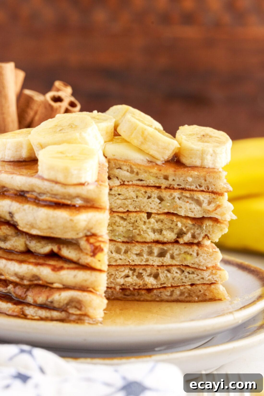 Fluffy Banana Bliss 3 Stack of Fluffy Banana Pancakes with a wedge cut out, showing the moist interior