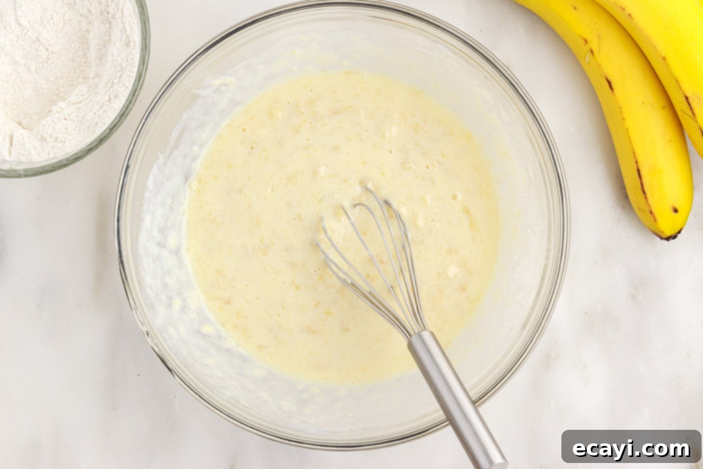 Fluffy Banana Bliss 8 Whisking the wet ingredients to form a smooth banana pancake batter