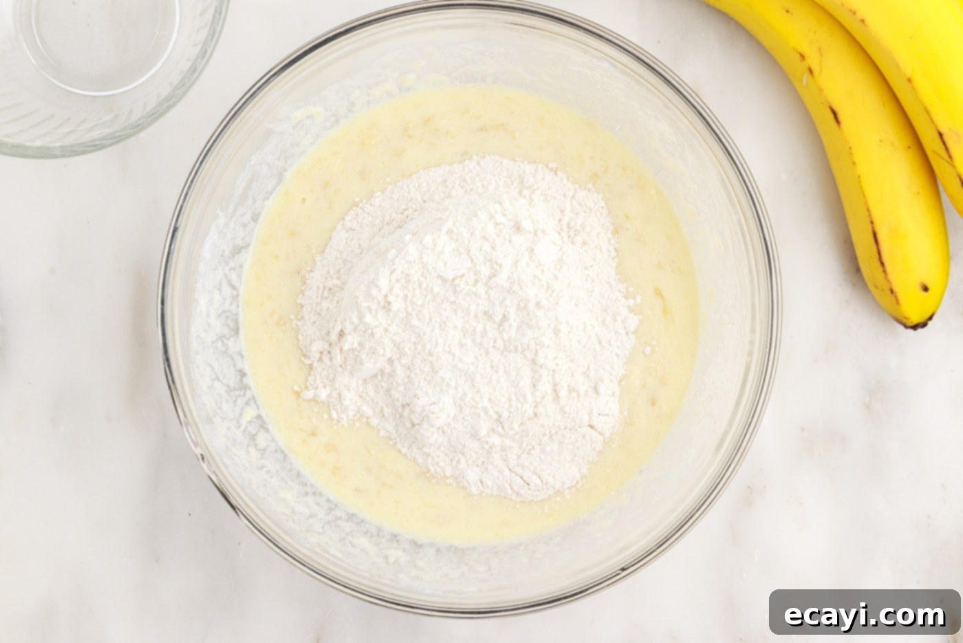 Fluffy Banana Bliss 9 Adding dry ingredients to the wet banana pancake batter