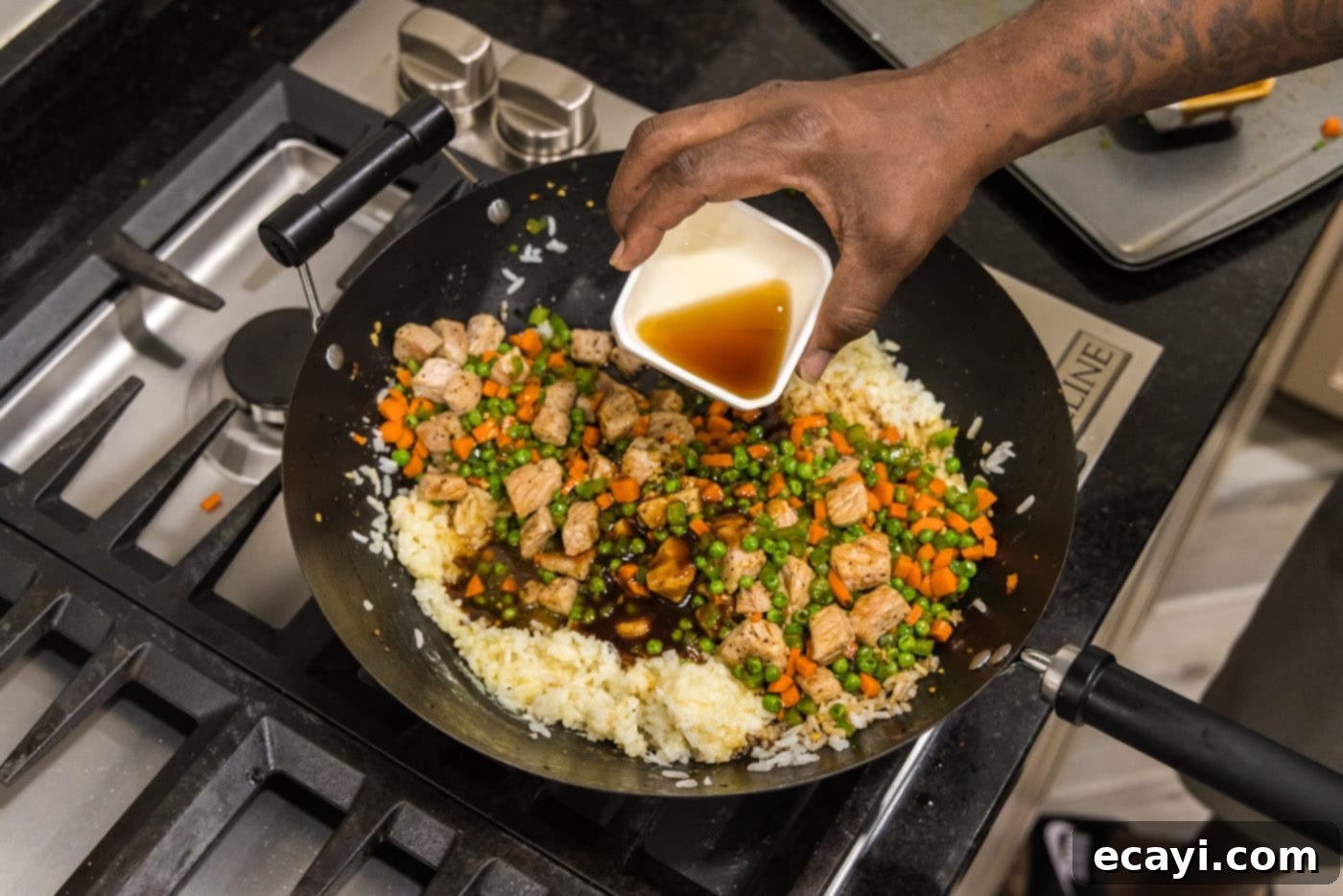 Wok-Fired Pork Fried Rice 16 Drizzling sesame oil over the nearly finished pork fried rice in a large skillet
