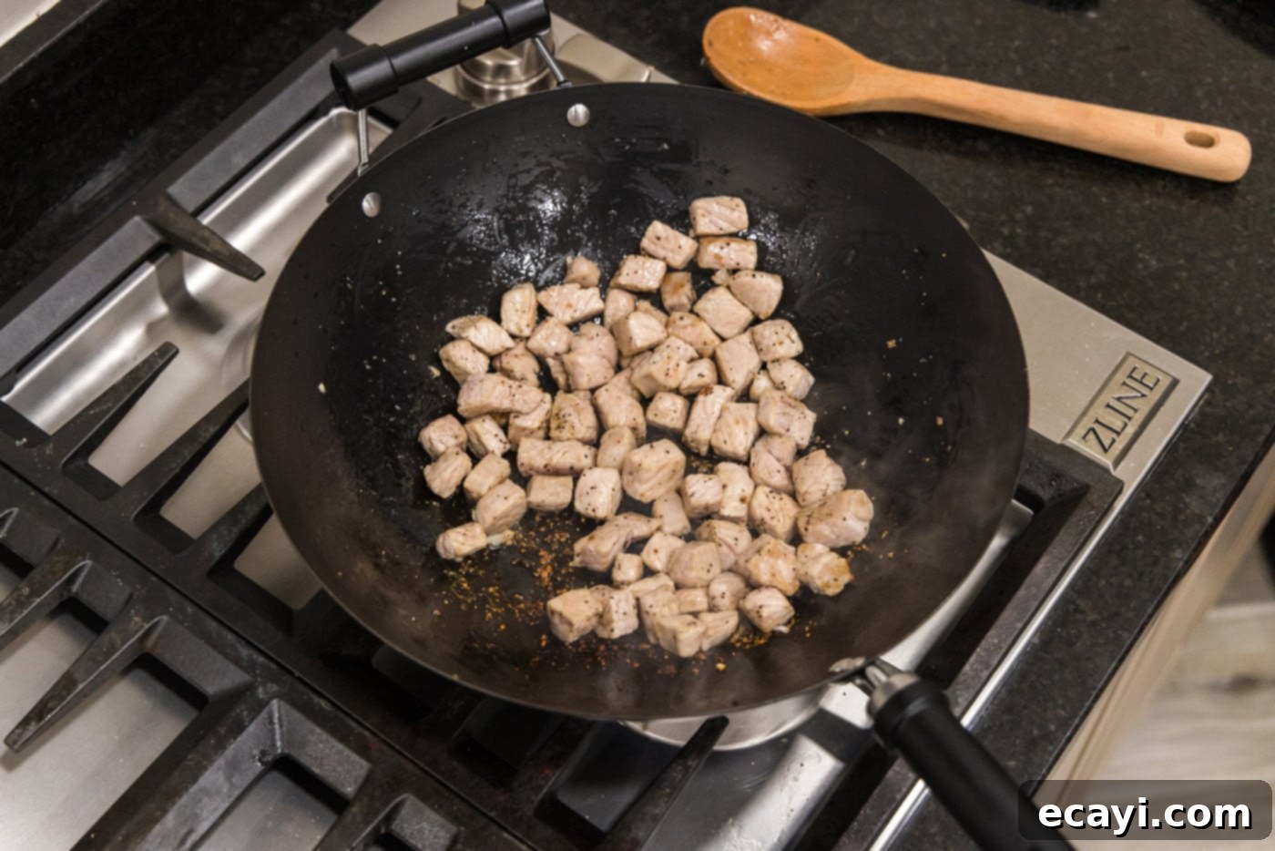 Wok-Fired Pork Fried Rice 8 Fully cooked and slightly browned diced pork chops in a wok after stir-frying