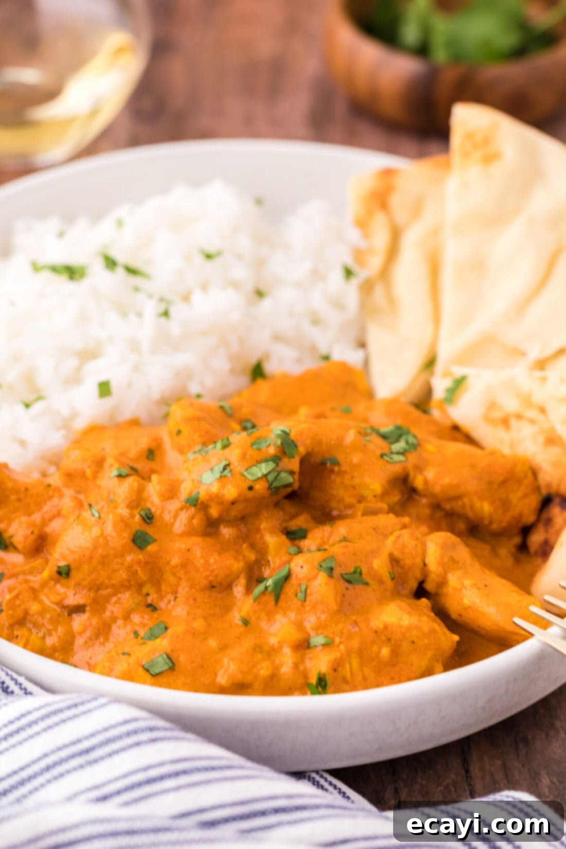Chicken Tikka Masala 2 Close up of a bowl of Chicken Tikka Masala with rice, showcasing the vibrant orange sauce and tender chicken pieces.