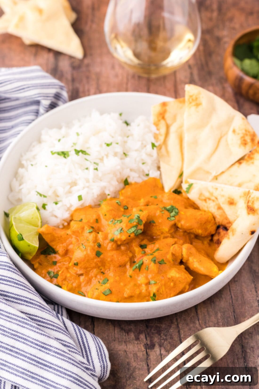 Chicken Tikka Masala 5 A beautifully presented bowl of Chicken Tikka Masala, accompanied by a side of fragrant basmati rice and warm naan bread, ready to be enjoyed.