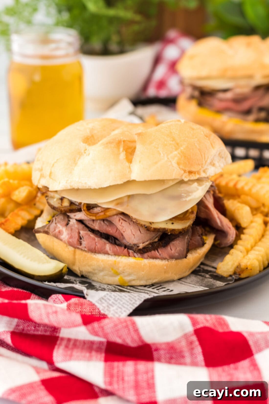 Tender Roast Beef Perfection 14 A completed roast beef sandwich on a plate with crispy crinkle-cut fries