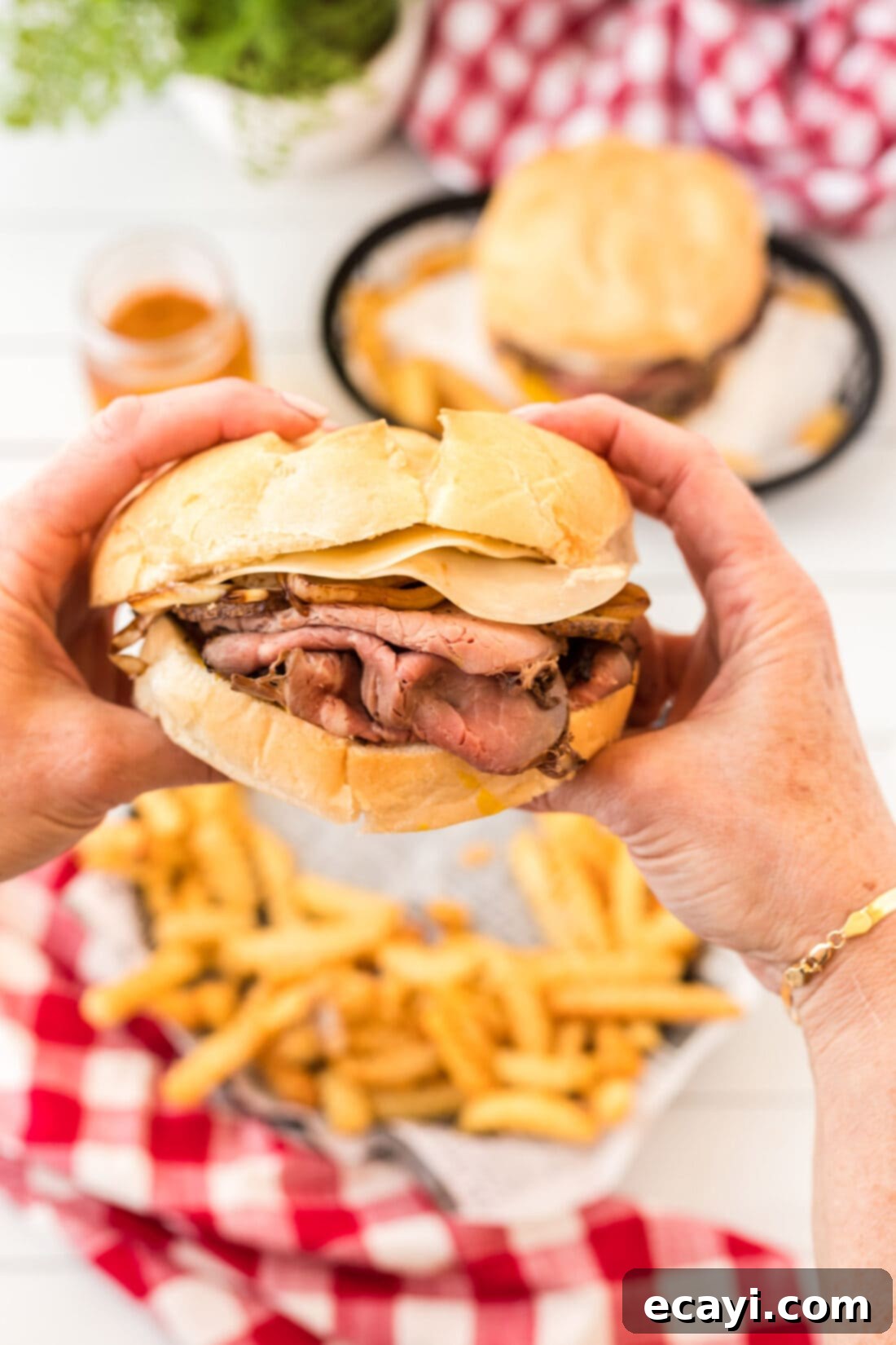 Tender Roast Beef Perfection 3 Two hands holding a hearty roast beef sandwich, showcasing its layers