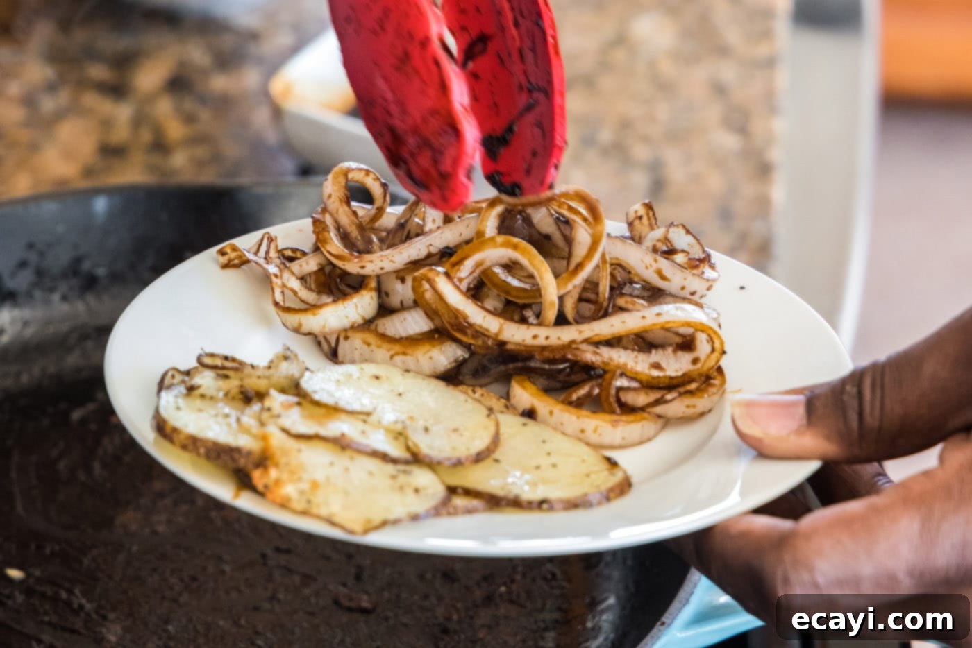 Tender Roast Beef Perfection 8 A plate featuring cooked balsamic glazed onions and sautéed potato slices, ready for assembly