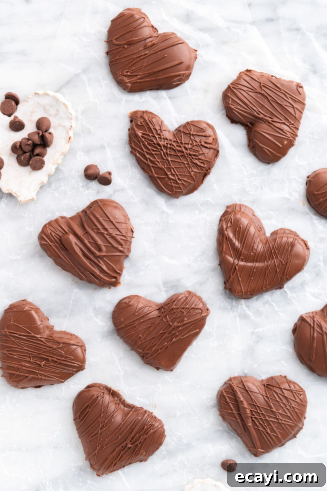 Decadent Chocolate Peanut Butter Hearts 2 Chocolate Peanut Butter Hearts on a piece of parchment paper with chocolate chips