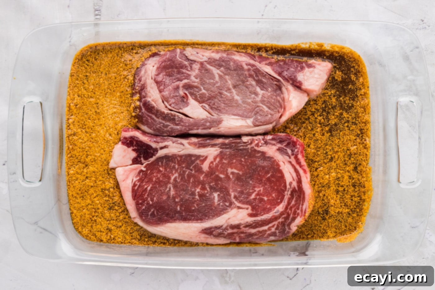 The Perfect Ribeye Marinade 7 ribeye steak soaking in marinade in a dish