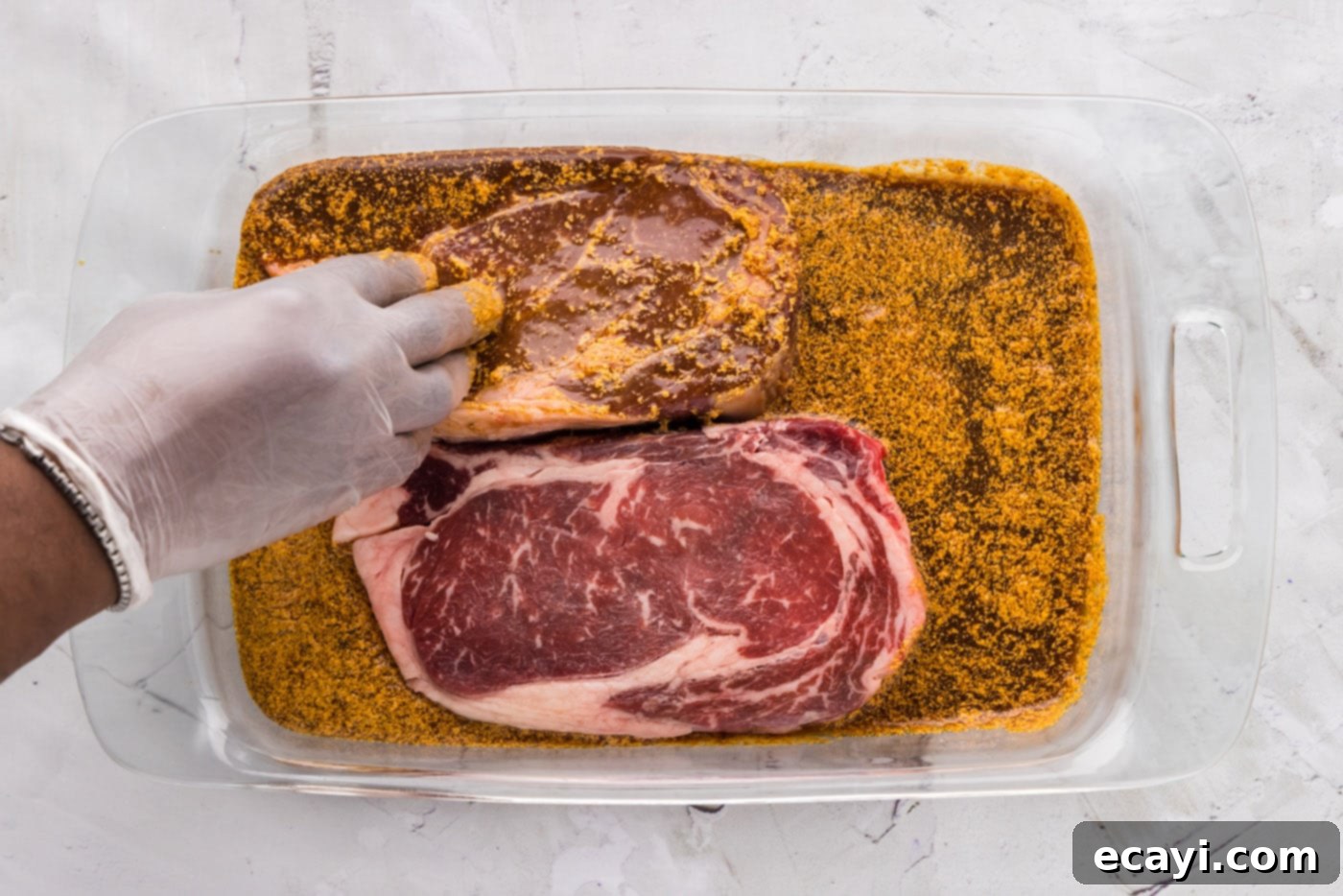The Perfect Ribeye Marinade 8 coating ribeye steak in marinade by hand