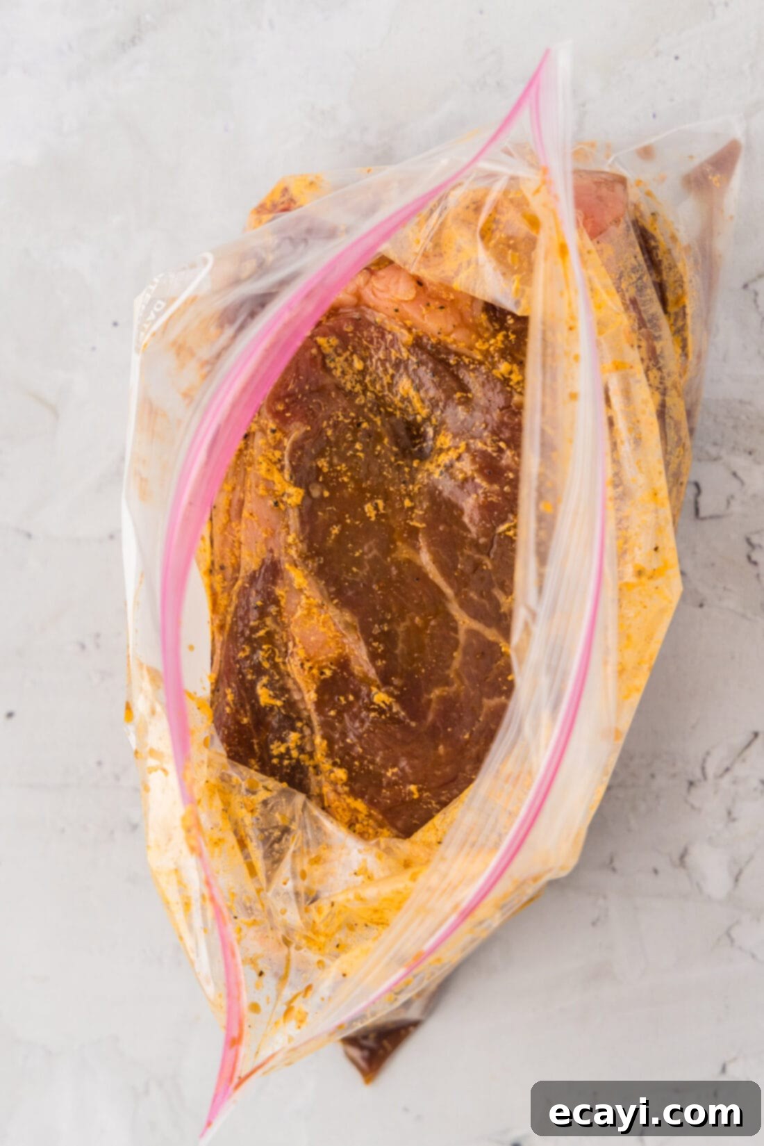 The Perfect Ribeye Marinade 10 Ribeye Steak Marinade in an open zipper bag showing the steak soaked