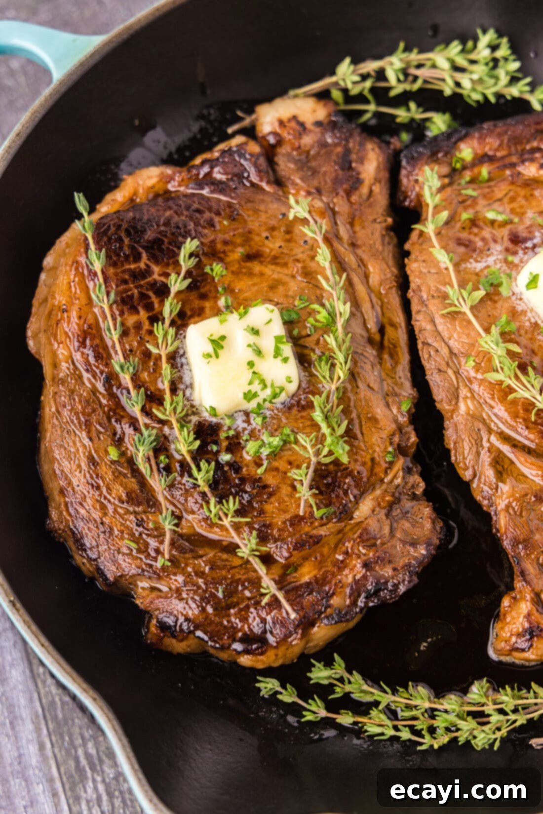 The Ultimate Cast Iron Ribeye 2 Close up of a Cast Iron Ribeye in a cast iron pan, showing a beautiful crust