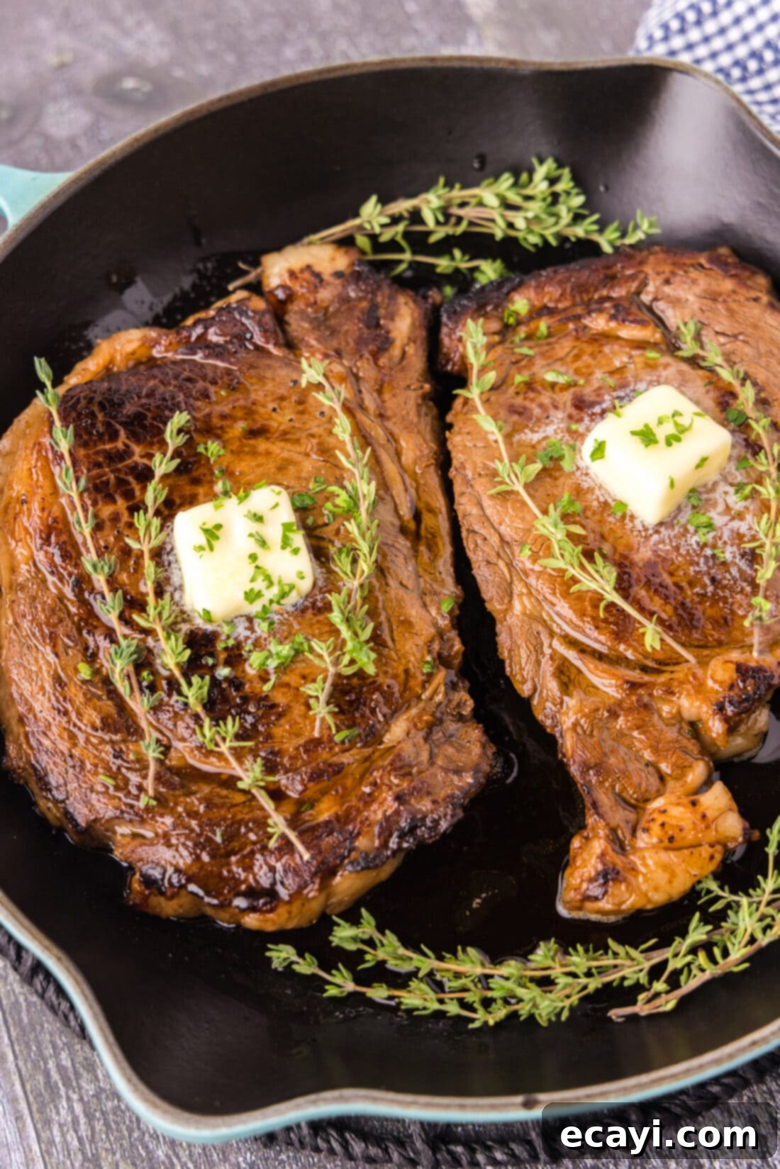 The Ultimate Cast Iron Ribeye 3 Two perfectly seared Cast Iron Ribeyes in a cast iron pan, ready to rest