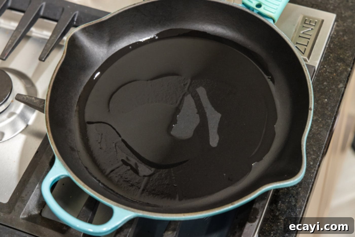 The Ultimate Cast Iron Ribeye 5 Olive oil shimmering in a hot cast iron skillet